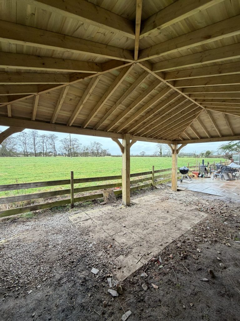 Timber gazebo roof structure overlooking fields