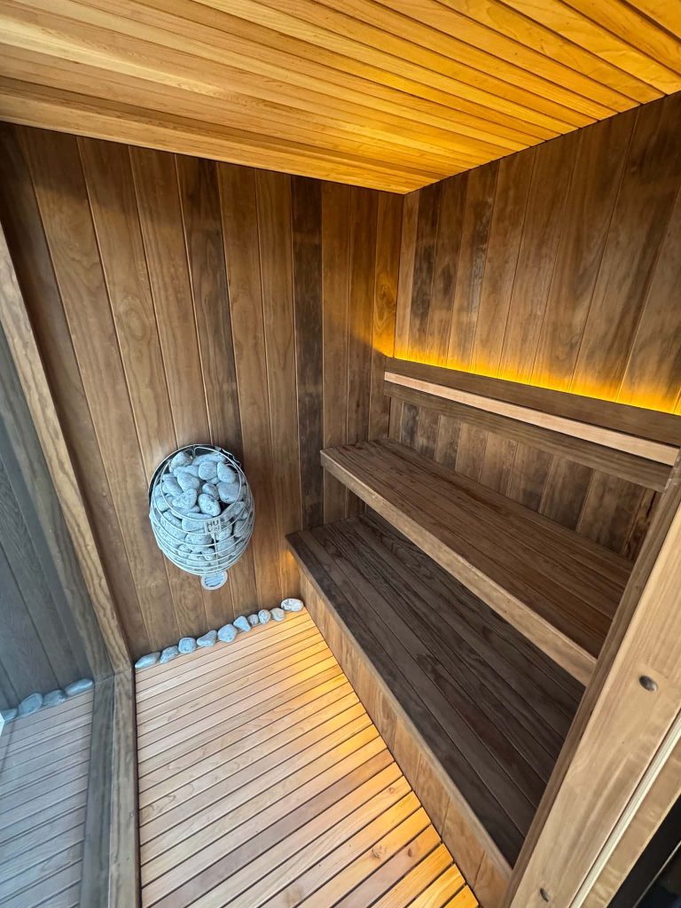 Cedar sauna interior with benches and stove