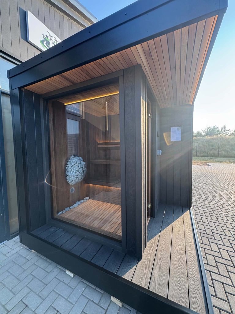 Black outdoor sauna with glazed door