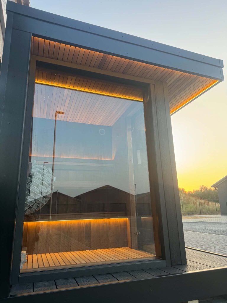 Outdoor sauna with full-height glass front