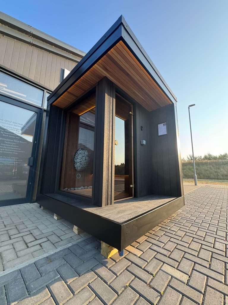 Black outdoor sauna with glazed door